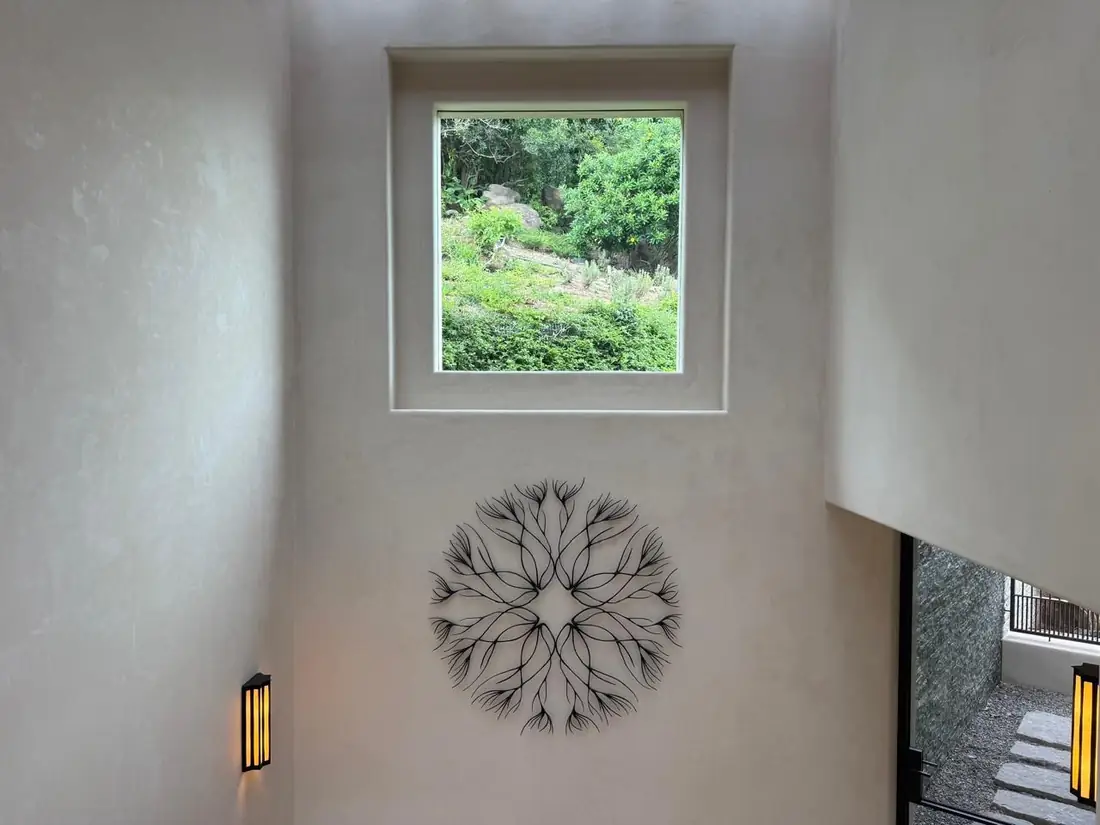 Finished interior chukum wall with a small window and a carved rosette; the surface shows the soft mottling of the material